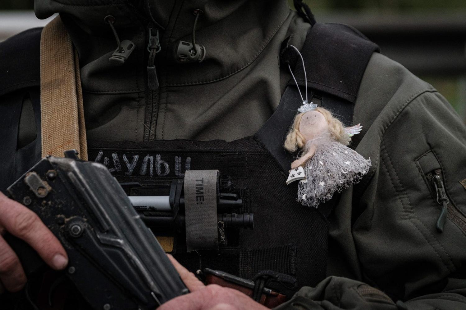 A Ukrainian soldier in Sloviansk, eastern Ukraine, wears an angel ornament given to him by his daughter, 29 April 2022 (Yasuyoshi Chiba/AFP via Getty Images)